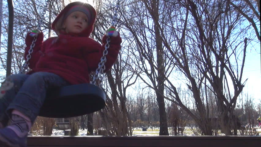 Child Swinging in Park, Winter Season 

