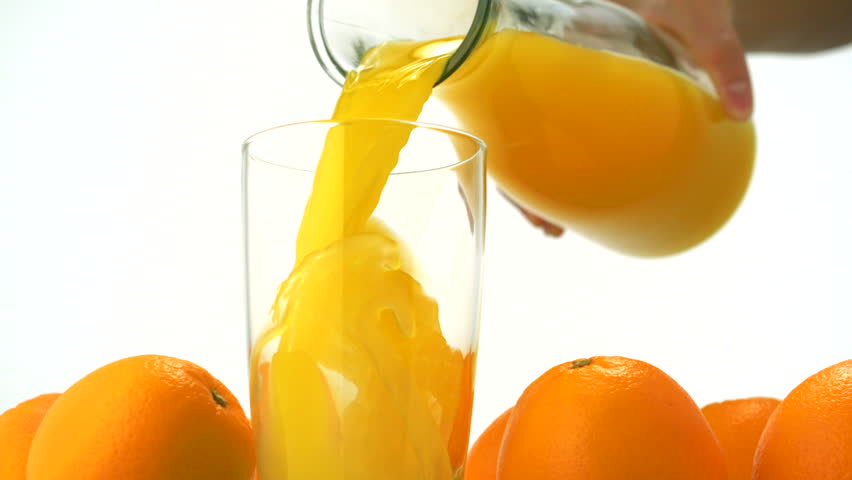 Pouring orange juice into glass shooting with high speed camera.
