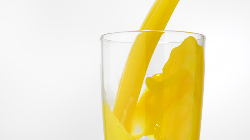 Pouring orange juice into glass shooting with high speed camera.