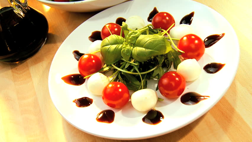 Temptingly displayed fresh crisp salad, mozzarella cheese & oils making a healthy nutritious meal