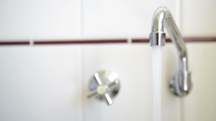 Water flowing out of a running chrome tap