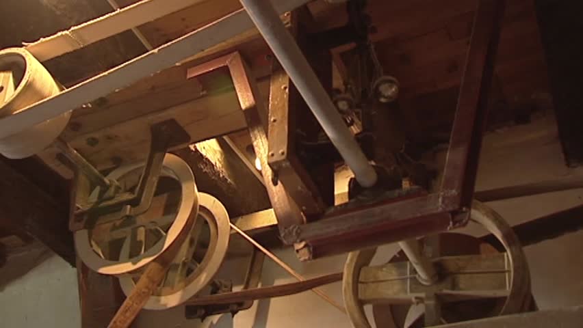 interior gristmill, turning wheels and belts  in historical gristmill