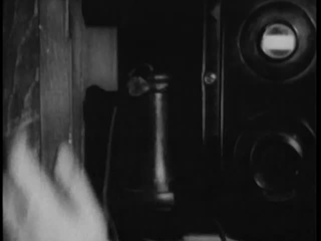 Close-up of man picking up telephone receiver