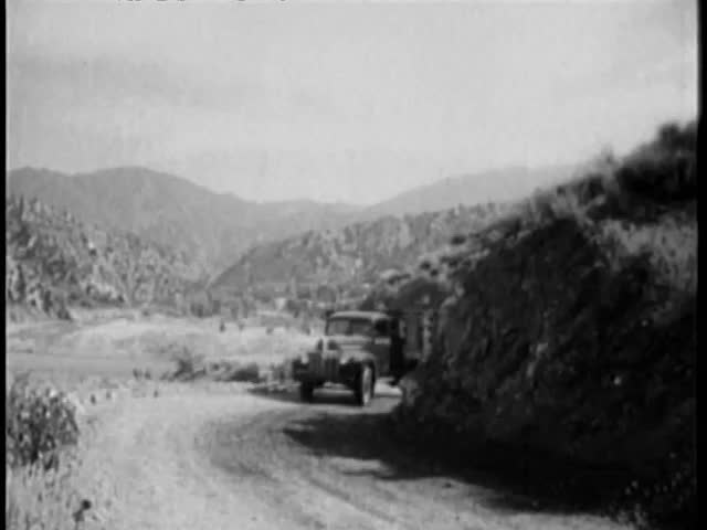 Fast moving truck making a turn on country road