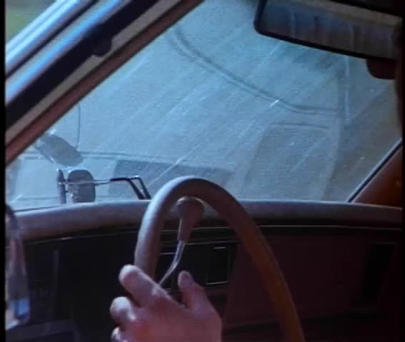 Person placing warning flasher light on police car dashboard