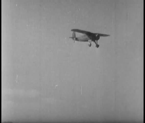 Wide shot of propeller airplane flying