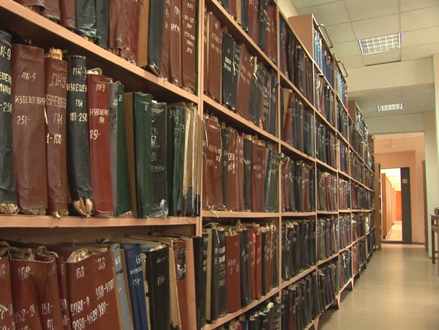 the sequence of shots of shelves with old folders (documents and drafts)