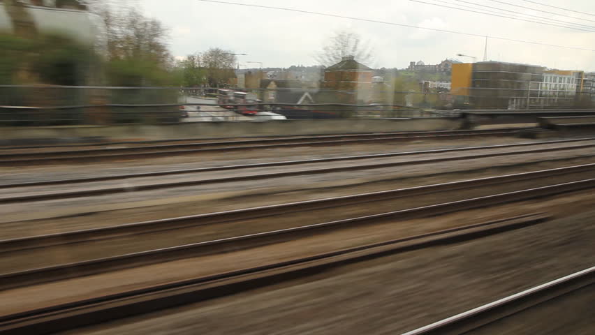 Train travel UK. Past flats and houses.
Travelling by train on the East Coast main line. North of London, UK. Travelling past modern flats and old houses.
