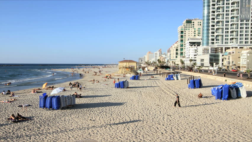 people and recliners at the beach in stop motion