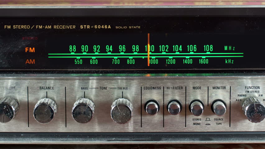 stop motion of a vintage radio receiver with frequency dial moving with a funky wallpaper background
