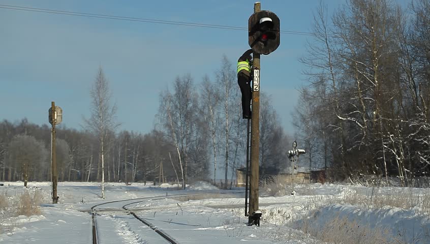 Railroad worker finish checking signal beacons