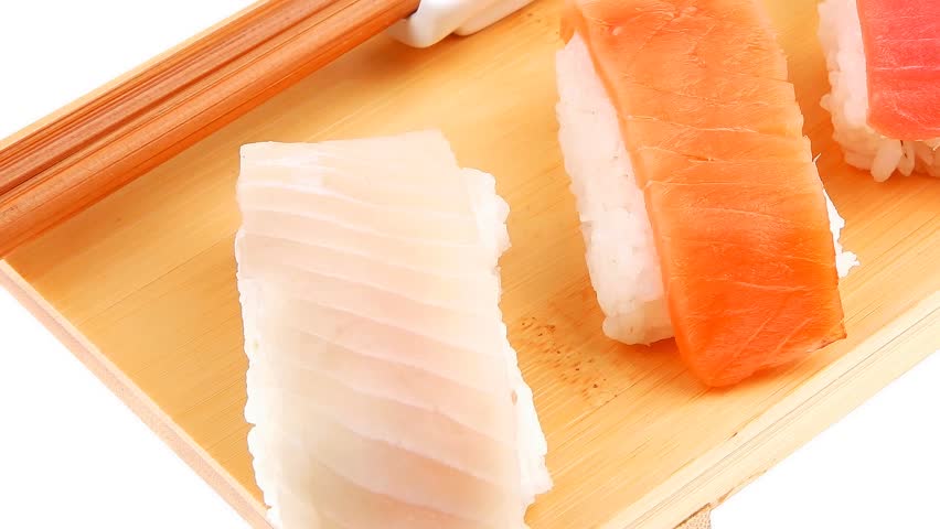 Japanese traditional cuisine - Set of Tuna (maguro) Salmon (sake) and Eel (unagi) Nigiri Sushi with Wasabi and chopstick on wooden plate hidef slow motion