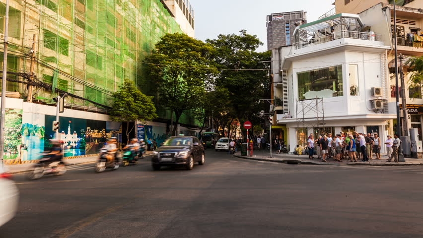 HO CHI MINH CITY, VIETNAM - JANUARY 27, 2013: Timelapse view of traffic at a crossing in Saigon City Center. Unrecognizable people can be seen in the scene.