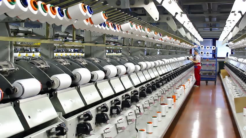 Workers in the textile industry ; workers serving machine in the production of synthetic fibers,video clip