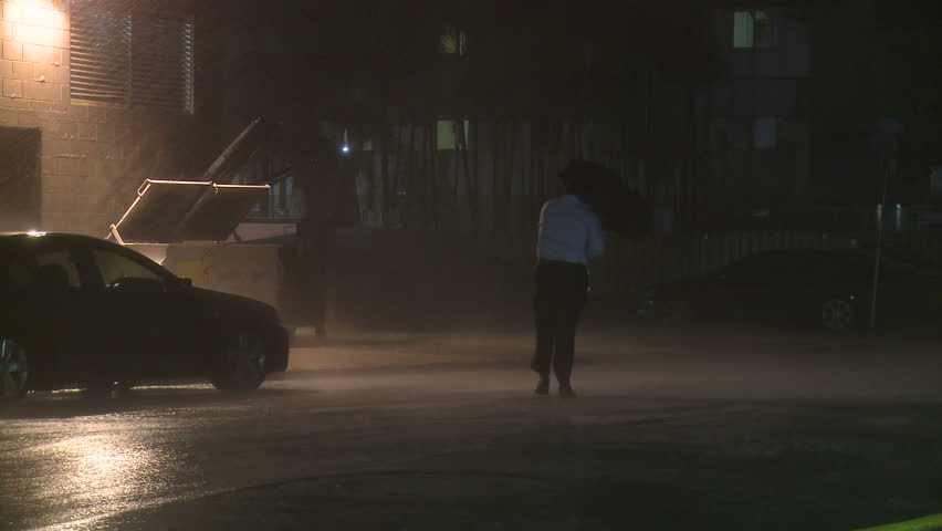 DARWIN, AUSTRALIA - FEBRUARY 2011. Torrential Rain Lashes Man In Tropical Storm - Full HD 1920x1080 30p shot on Sony EX1. 