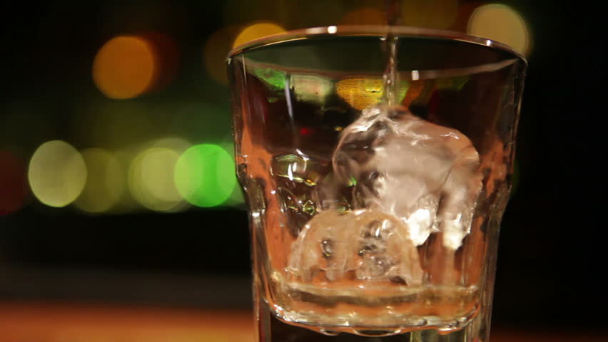 Tracking shot of serving whiskey