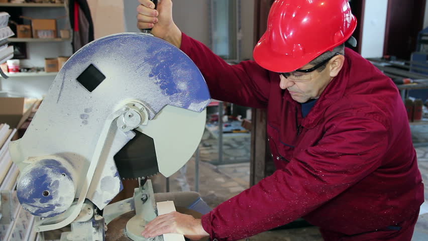 Worker Cutting PVC Profile with Circular Saw.
PVC windows and doors manufacturing. HD1080p. 