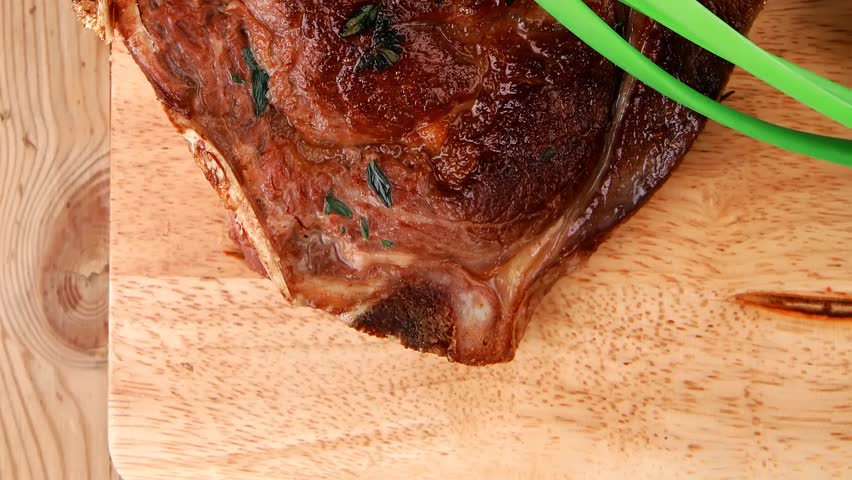 meat savory : roasted beef ribs served with green chives over black table