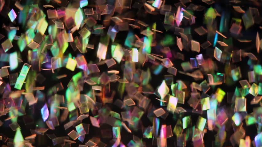 Beautiful colorful glitter floating and swirling in water.