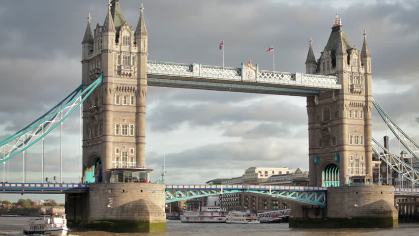 Stationary shot of Tower Bridge, white ship on the left, located in London, England.