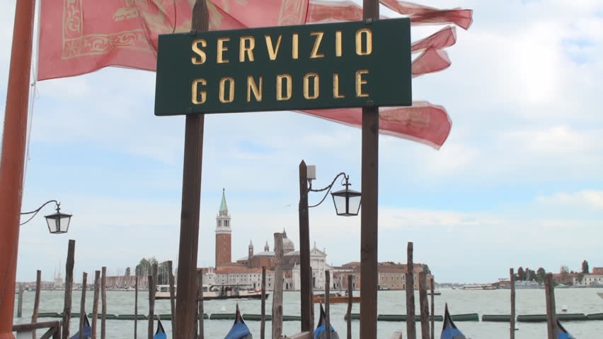 VENICE, ITALY - MAY 11: Gondola sign with gondolas in the lagoon of Venice on May 11, 2012. Gondolas are now mainly used for touristic purposes but where once the main form of transportation in Venice