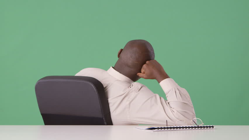 African American businessman bored at desk