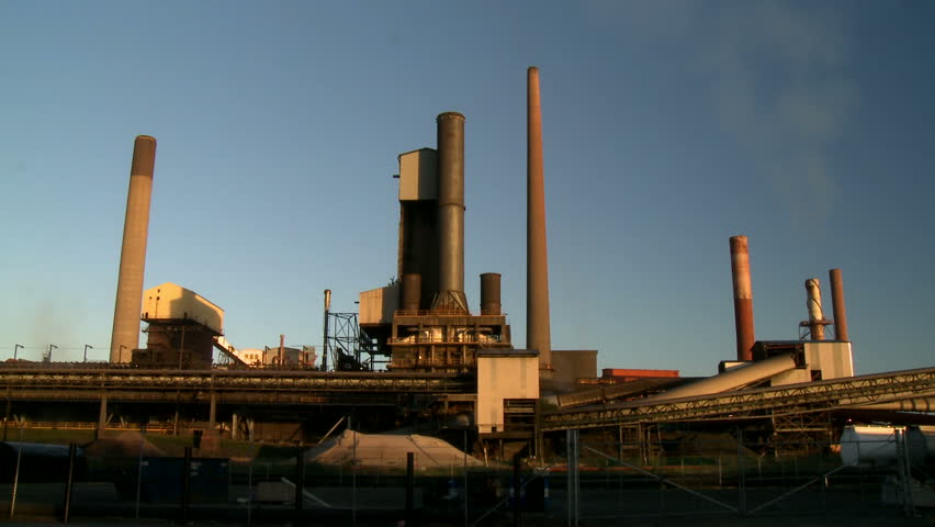 Steel Mill Smokestack starts Pouring Smoke.