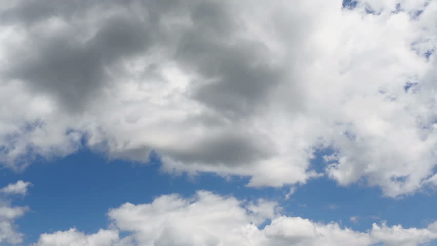 Time lapse clip of white fluffy clouds over blue sky