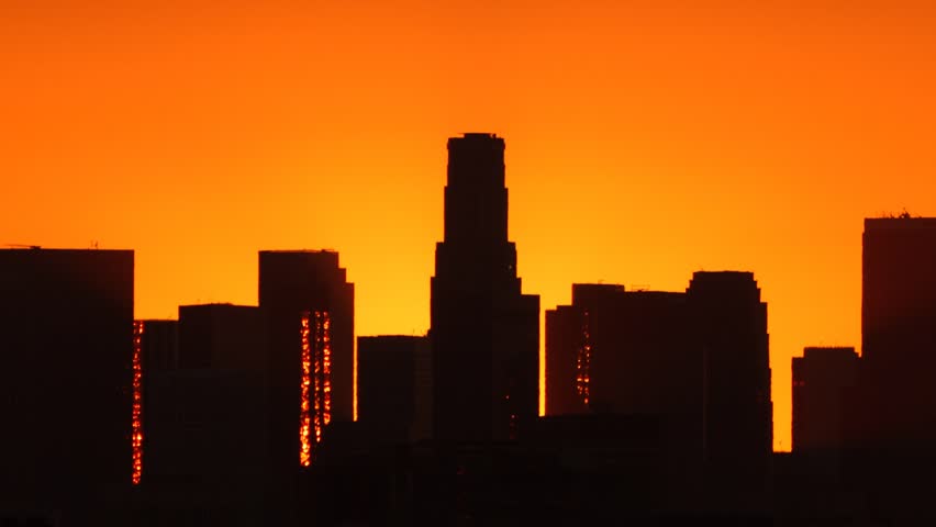 Los Angeles skyline sunrise. Pan and zoom out. Timelapse. Silhouette with Flare. 