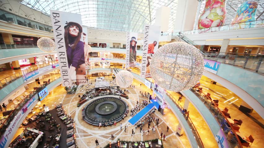 MOSCOW - SEP 7: Buyers are visit shops in shopping center Afimall on September 7, 2011 in Moscow, Russia. Advertising banners and decorative balls as though floating in the air.