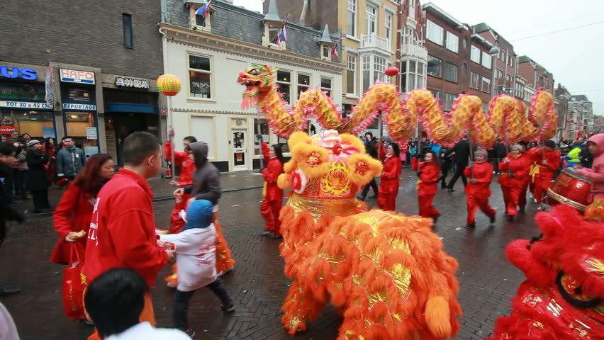 THE HAGUE, HOLLAND - JANUARY 9: Fire crackers and dragons on Chinese New Year in Chinatown in The Hague, Holland on January 9, 2013. Dragons customarily visit shops to receive gifts.