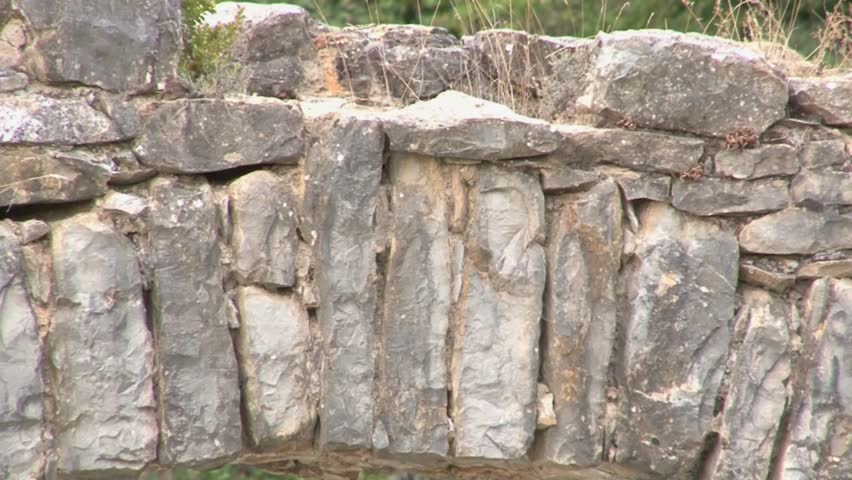 Historical bridge over a dry riverbed in the Pyrenees, zooming out.