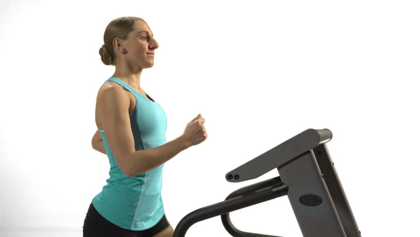 Young woman on the Treadmill in front of white screen, close up