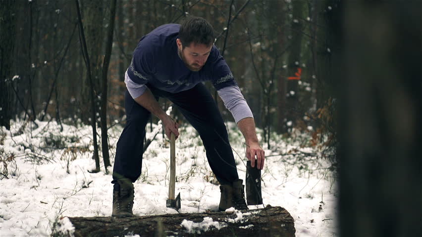 Lumberjack strong man chopping timber axe, slow motion shot at 120fps, steadycam shot
