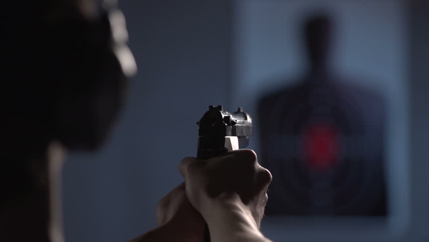 Over the shoulder of shooter, practicing on a target