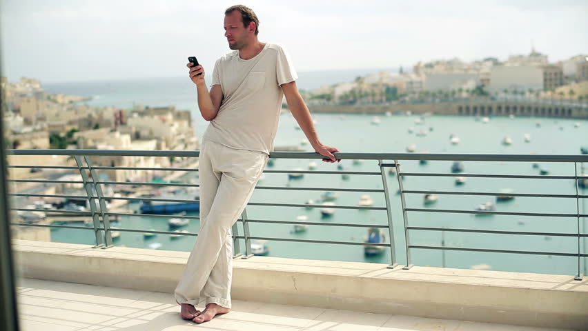 Young man using cellphone on the terrace

