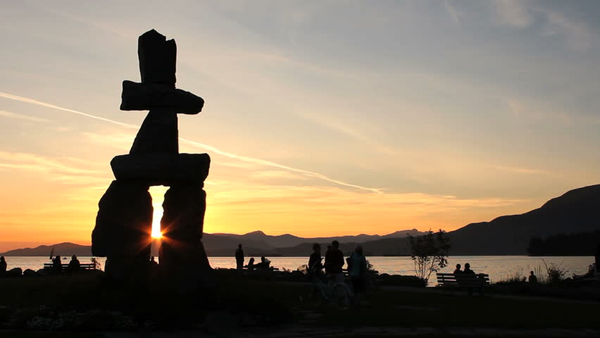 Vancouver Inukshuk Sunset. A large, stone, Inukshuk overlooking English Bay at sunset in Vancouver, British Columbia, Canada.