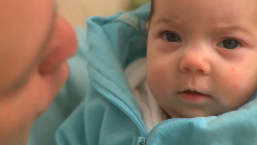 A two month old infant looks into camera