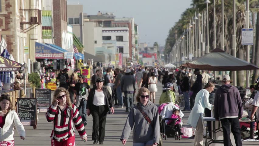 VENICE, CALIFORNIA - MARCH 3: Tourists and locals enjoy the unique atmosphere of the Venice Beach boardwalk on March 3, 2013 in Venice, California