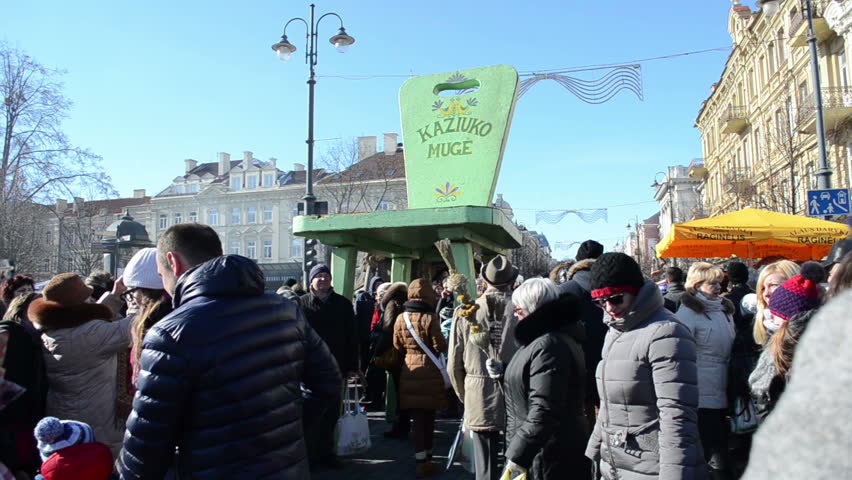 VILNIUS, LITHUANIA - MARCH 02: Huge chair stand in center of street Kaziukas Casimir spring fair and people entertain on March 02, 2012 in Vilnius.