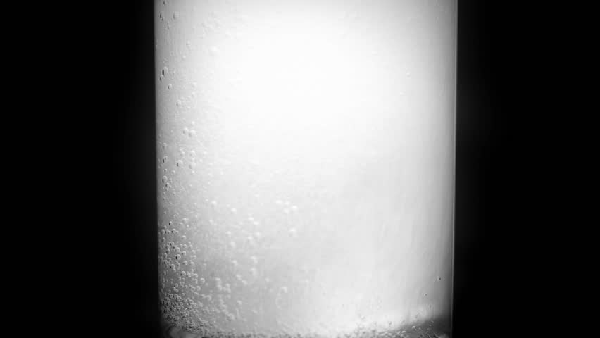 Aspirin tablet in glass of water