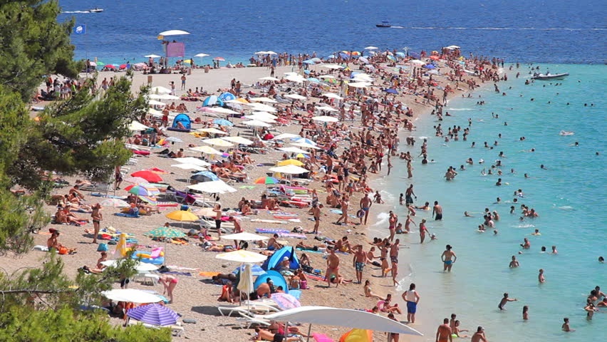 People on the beach, sunbathing and swimming, enjoying on vacation. Famous beach in Bol on Island Brac in Croatia