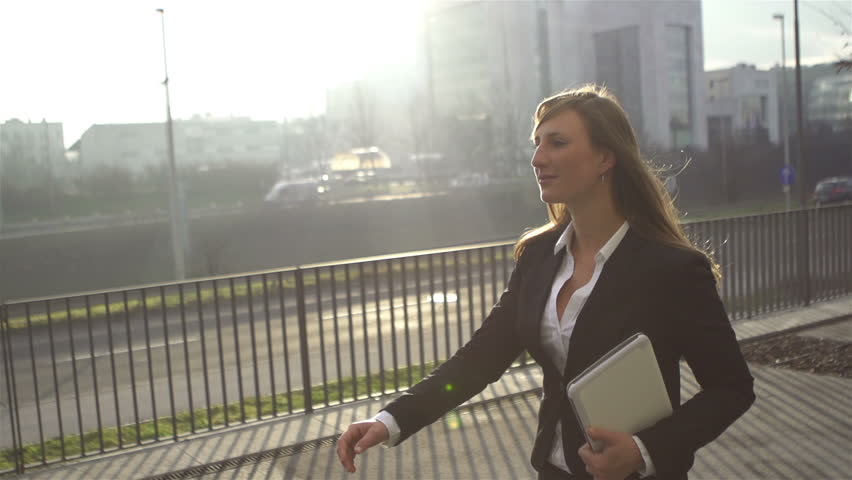 SLOW MOTION: Young businesswoman going to work in the morning