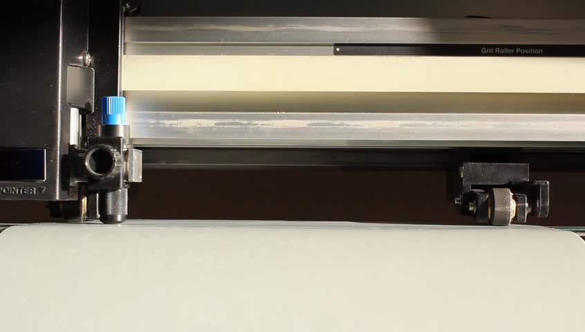 Cutting plotters use knives to cut the letters on gray vinyl film. Bottom view of the average plan