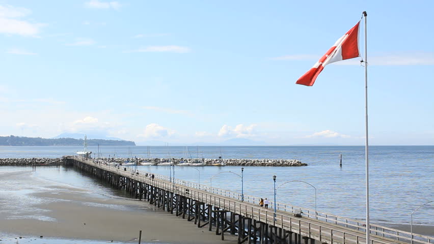 White Rock Pier and Beach, British Columbia. White Rock beach and the pier that leads out to it's marina. White Rock beach is close to the US/Canada border on British Columbia's coast. Canada.
