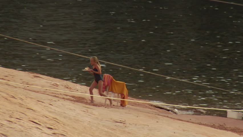 young girl runs from houseboat to family on Lakeshore
