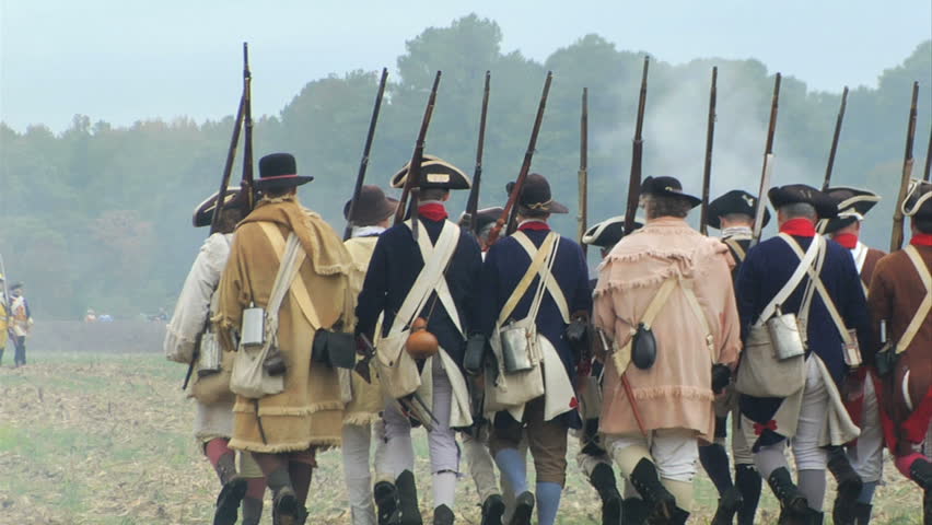 VIRGINIA - OCTOBER 2009 - large-scale, epic American Revolutionary War anniversary reenactment -- in the middle of battle.  Continental Army in line of battle marches away from camera in attack.