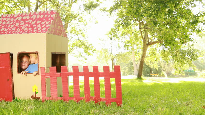 Video of happy little children sitting in playhouse. 