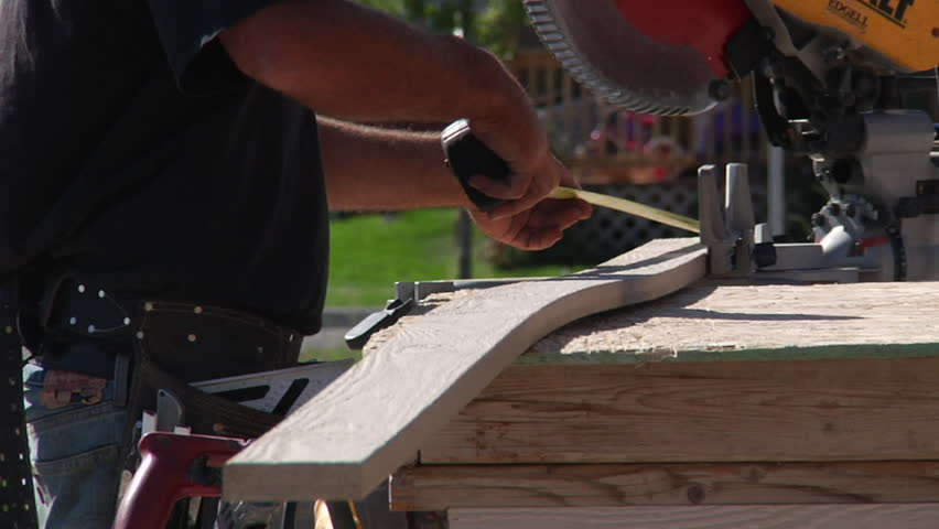 measuring lumber for cutting