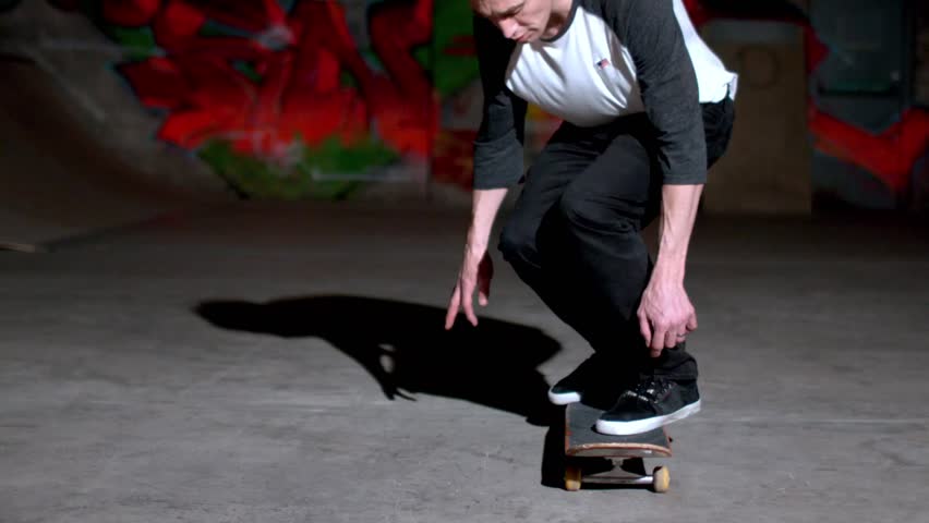 Front view of skater doing 360 flip in slow motion